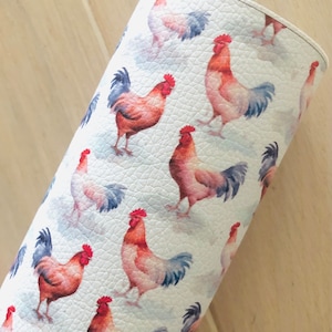 May include: White faux leather fabric with a repeating pattern of watercolor roosters. The roosters are red, orange, and blue.