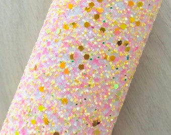 May include: A close-up of a white, pink and gold glitter fabric. The fabric is covered in small, sparkly glitter pieces.