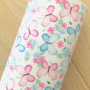 May include: White faux leather fabric with a repeating pattern of pink and blue butterflies and small flowers.