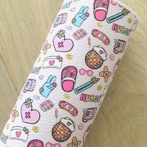 May include: Pink and white patterned fabric with a variety of nurse-themed illustrations, including hearts, bandages, pills, stethoscopes, and the word "NURSE".