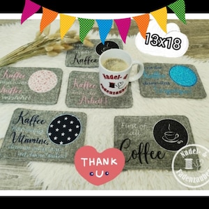 May include: Set of 8 gray felt coasters with embroidered designs. The coasters feature coffee-themed designs, including a cup of coffee, stars, and the text "Kaffee Vitamine" and "First of all Coffee".