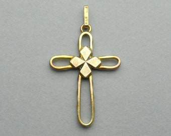 May include: A gold-toned metal cross pendant with a four-pointed star design in the center.