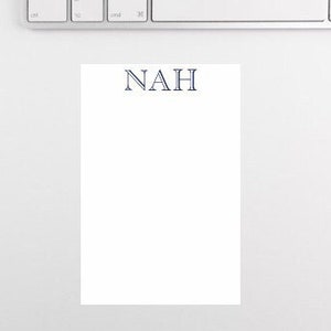 May include: A white notepad with the word "NAH" printed in navy blue letters.
