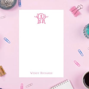 May include: Pink monogrammed stationery with the initials "WR" in a script font. The name "Wendy Richards" is printed at the bottom of the page.