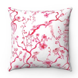 May include: Pink and white throw pillow with a floral pattern featuring a repeating design of branches, flowers, and pagodas.