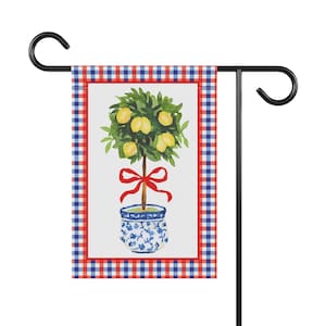 May include: A garden flag with a red, white, and blue gingham pattern. The flag features a watercolor illustration of a lemon tree in a blue and white planter with a red bow.