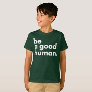 May include: A dark green t-shirt with white text that reads "be a good human."
