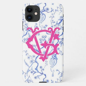 May include: A white iPhone case with a blue and white floral pattern and a pink monogram "VF" in the center.