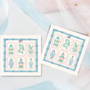 May include: Two square gift tags with a bamboo-style border in blue. Each tag features six illustrations of vases, pagodas, and birds in a soft color palette of blue, pink, and green. A small hole is at the top for hanging.