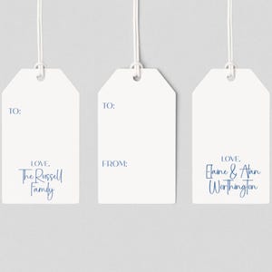 May include: Three white gift tags with a string attached. Each tag has the word "TO:" printed at the top. The first tag says "LOVE, The Russell Family". The second tag says "FROM:". The third tag says "LOVE, Elaine & Alan Worthington".