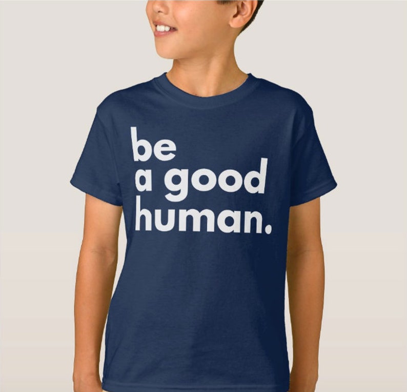 May include: A navy blue t-shirt with white text that reads "be a good human."