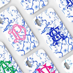 May include: A set of six white phone cases with a blue and white floral pattern. Each case features a different colored monogram in the center.