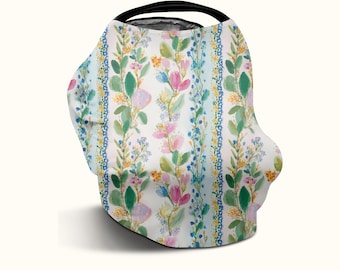 Könnte beinhalten: Ein Mehrzweck-Autositzbezug mit vertikalem Streifenmuster, das Aquarell-Illustrationen von rosa, gelben und blauen Blumen, grünen Blättern und dünnen blauen Ranken auf weißem Hintergrund zeigt, gekrönt von einem schwarzen, runden Griff.