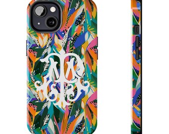 May include: A colorful phone case with a white monogram in the center. The case features a tropical leaf pattern in shades of blue, green, orange, and pink.