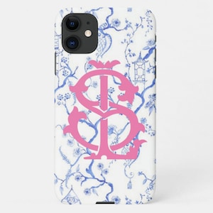 May include: A white iPhone case with a blue and white floral pattern and a pink monogram "IS".