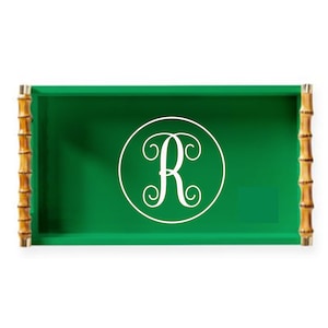May include: A green serving tray with bamboo handles and a white monogram of the letter "R" in a circle.