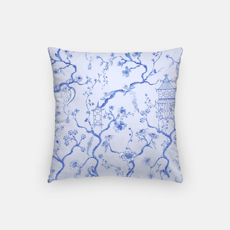 May include: Blue and white throw pillow with a floral pattern featuring a traditional Chinese design. The pillow has a square shape and a soft, comfortable feel.
