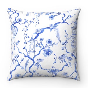 May include: Blue and white throw pillow with a floral pattern featuring branches, flowers, and lanterns. The design is reminiscent of traditional Chinese porcelain.