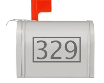 May include: A white mailbox with a red flag and the number 329 printed on the front.