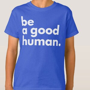 May include: A royal blue t-shirt with white text that reads "be a good human."