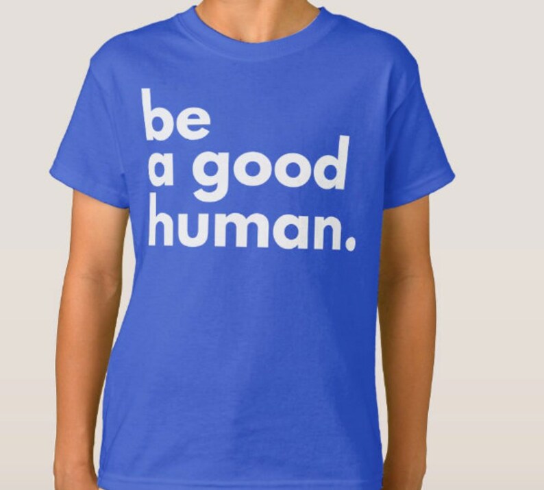 May include: A royal blue t-shirt with white text that reads "be a good human."