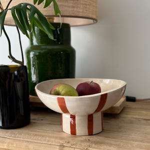 Handcrafted ceramic fruit bowl. Terracotta/brick red slip stripes