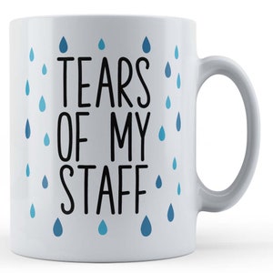 May include: White ceramic coffee mug with a black and white design that says "Tears of my staff" with blue raindrops around the text.