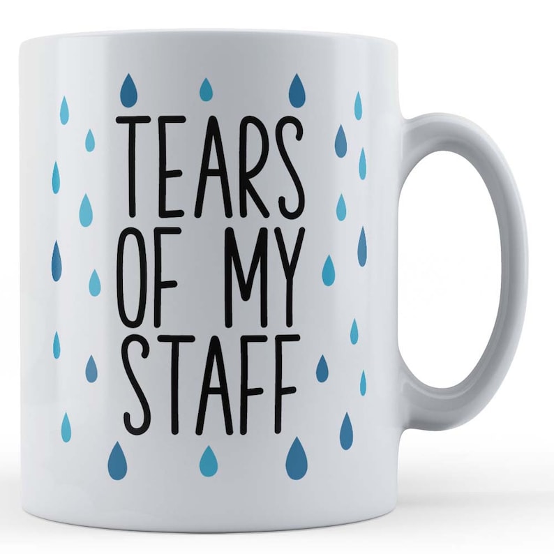 May include: White ceramic coffee mug with a black and white design that says "Tears of my staff" with blue raindrops around the text.