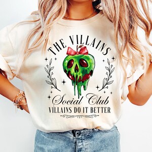 a woman wearing a white shirt with a skull on it