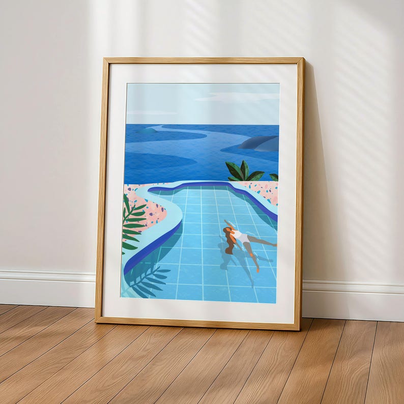 May include: Framed art print showing a person in a blue swimming pool with an ocean view. The artwork uses a minimalist style with blue, pink, and green hues. The print is in a light wood frame, ideal for home decoration, with measurements in cm.