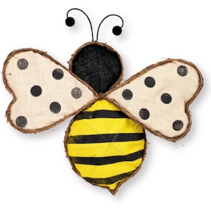 May include: A decorative bee with a yellow and black striped body, cream-colored wings with black polka dots, and black antennae. The wings have a brown, textured border. The bee is a whimsical, handcrafted item.