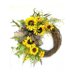Introducing our rustic summer sunflower grapevine wreath for your front door that embodies the timeless beauty of yellow floral farmhouse style. Handcrafted with sunflowers, wildflowers and greenery, this sunny wreath is sure to brighten your day.