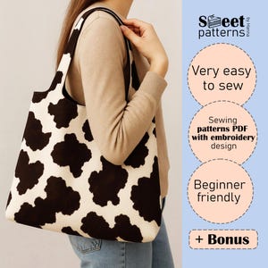 May include: A black and white cow print tote bag. The bag is being carried by a person. The image includes text: "Very easy to sew", "Sewing patterns PDF with embroidery design", and "Beginner friendly".