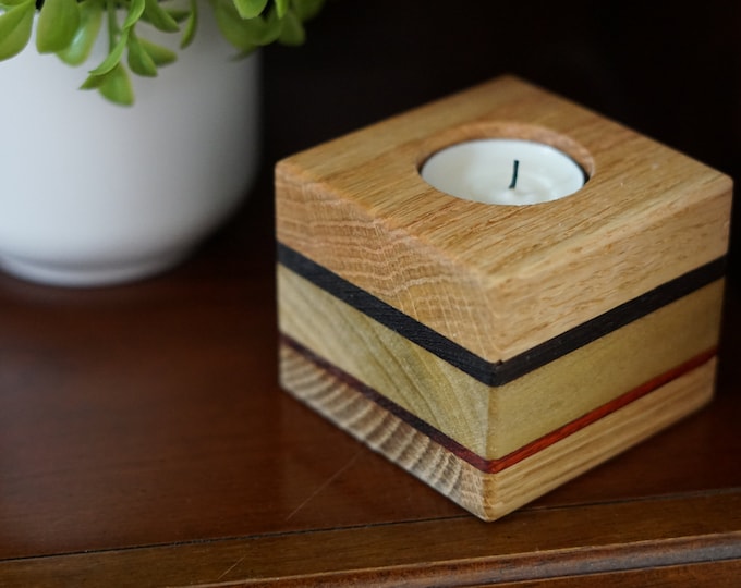 Votive candle holder handmade from five species of wood. Compliments cottage core or rustic decor. Nice 5th anniversary present.