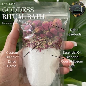May include: A clear plastic bag filled with a bath soak. The soak contains dried rosebuds, herbs, and coarse Epsom salt. The bag is labeled "Goddess Ritual Bath" and "Premium Quality Ritual Oils".