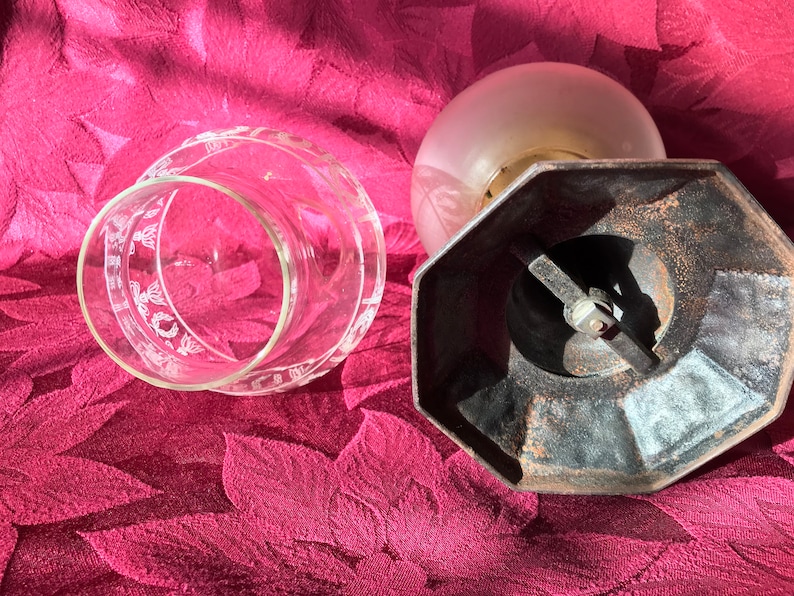 May include: A vintage glass lampshade with a frosted glass globe and a black metal base. The base has a hexagonal shape and a metal arm with a screw.