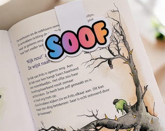 May include: A colorful bookmark with the word "SOOF" in a bubble letter style, placed on an open book. The bookmark has a white tab. The book's pages display text and an illustration of a tree.