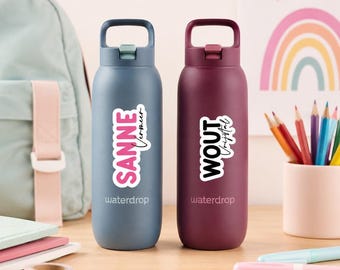 May include: Two waterdrop brand water bottles with carrying handles. The left bottle is matte blue with a white sticker reading SANNE Vermeer. The right bottle is matte burgundy with a white sticker reading WOUT Vrijstal. Both feature the waterdrop logo.