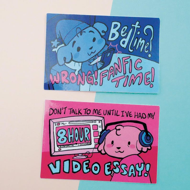 May include: Two stickers featuring cartoon dogs. The first sticker is blue and features a dog in a blue hat with the text "Bedtime? WRONG! FAN TIME!" The second sticker is pink and features a dog wearing headphones with the text "DON'T TALK TO ME UNTIL I'VE HAD MY 8 HOUR VIDEO ESSAY!"
