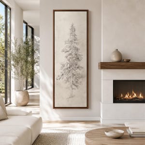 May include: A tall, vertical rectangular wall art piece featuring a detailed charcoal-style pencil sketch of a single evergreen tree. The artwork is encased in a thin, dark brown wooden frame and displays a neutral, off-white background.