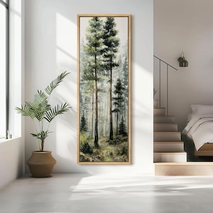May include: Vertical framed artwork featuring a watercolor painting of a forest scene. Tall, slender trees dominate the composition, with green foliage and brown trunks. The background fades into a misty, atmospheric effect, creating depth.