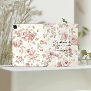 May include: An open tablet case with a floral rose pattern in shades of pink and beige. The text "Let all you do be done in love - Corinthians 16:14" is displayed on the right side of the case.