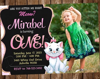 May include: A pink and gold birthday invitation with a photo of a young girl in a green dress. The invitation says "Are you kitten me right? Meow? Mirabel is turning ONE!" and includes the date, time, and location of the party. There is also a cartoon image of a white cat with pink accents.