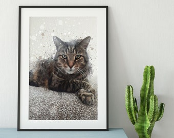 May include: Framed art print featuring a watercolor-style portrait of a tabby cat. The cat has brown and gray fur and is lying down. The print is in a black frame and is displayed on a light blue bench with a cactus and firewood.