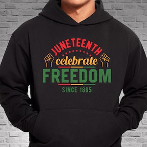 May include: Black hooded sweatshirt with a red, yellow, and green graphic that says "Juneteenth celebrate freedom since 1865".