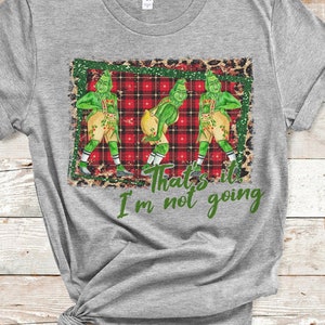 May include: Gray t-shirt with a graphic of three green figures in a red and black plaid pattern. The text "That's it I'm not going" is printed below the graphic.