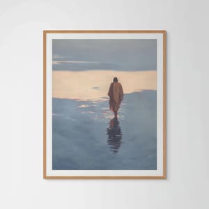 May include: A framed art print depicts a figure walking in water, with a reflection. The figure is wearing a brown robe, set against a backdrop of a dusky sky and water. The artwork is framed in a light brown wooden frame.
