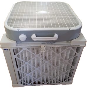 May include: A square box fan with a white plastic grille and a gray housing, featuring a white control knob and handle. Attached to the base is a pleated air filter with a white diamond-patterned frame, labeled with the size 19.5 x 19.5 x 1.75 inches.