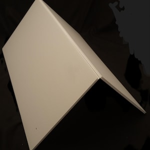 May include: A white, rectangular, corrugated plastic sheet folded in half to form a tent-like structure. The material features a subtle, vertical ribbed texture across its surface, creating a clean, angular profile with sharp, straight edges.