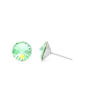 May include: A pair of silver stud earrings with light green crystal stones.